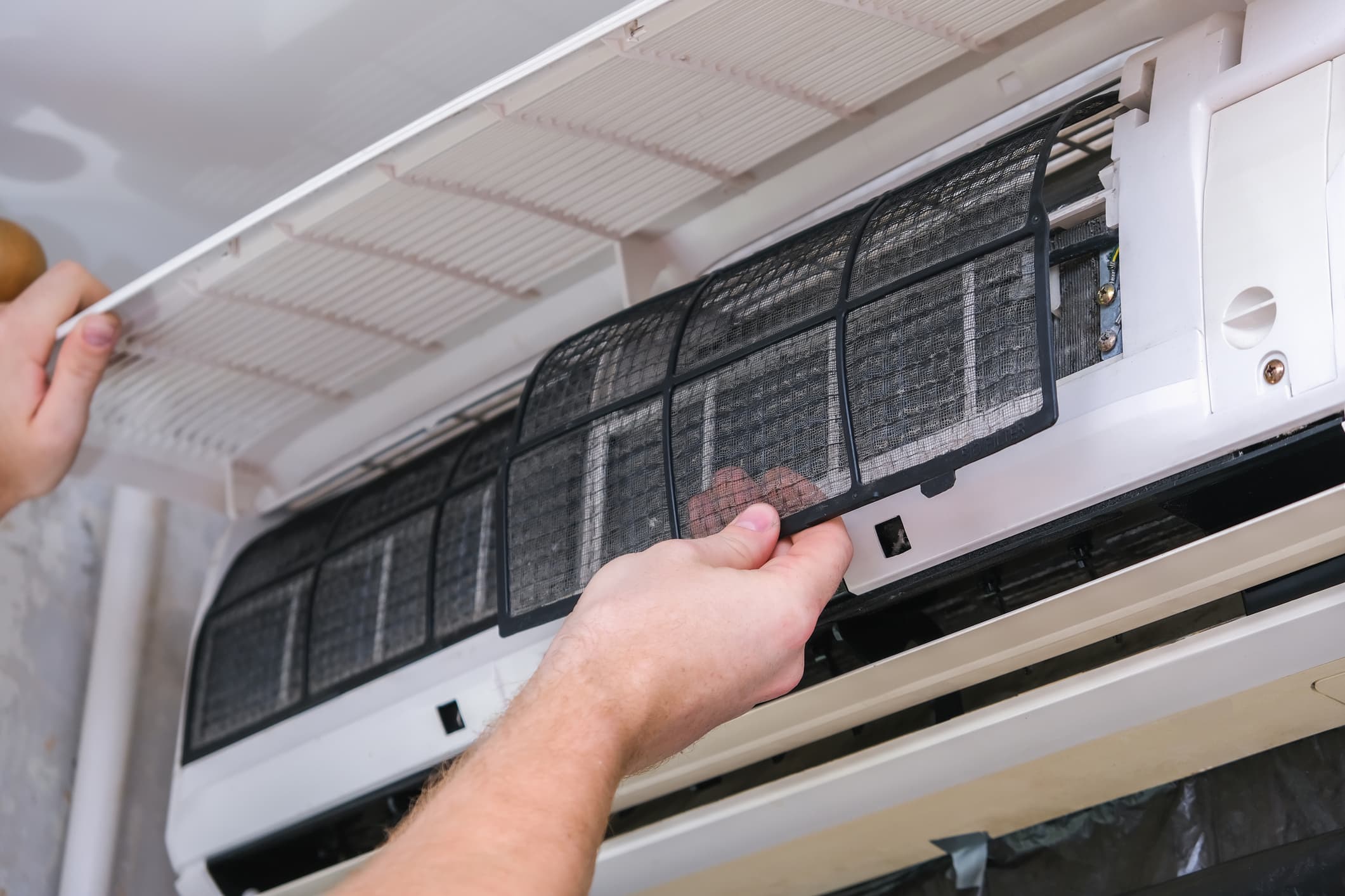 Mini-split filter being removed during a Vermont Heat Pump Cleaning visit