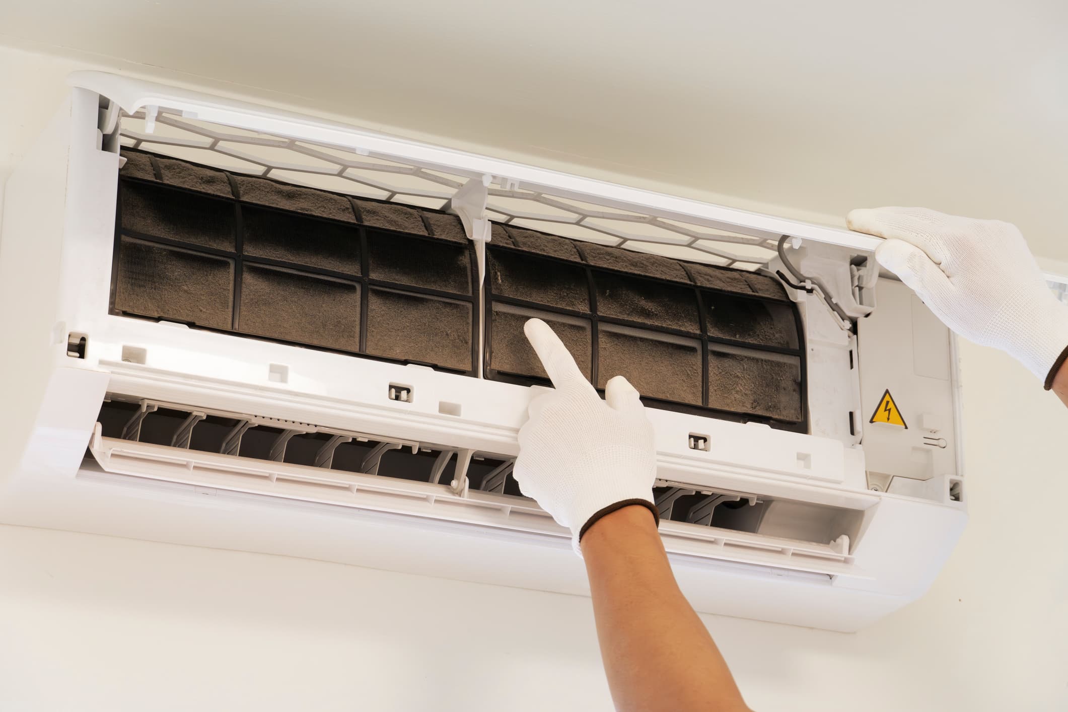 Mini-split with thick dust caked across the filter and air panel before cleaning